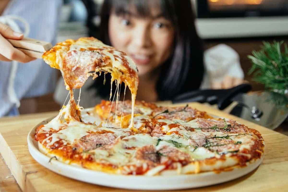 woman eating pizza