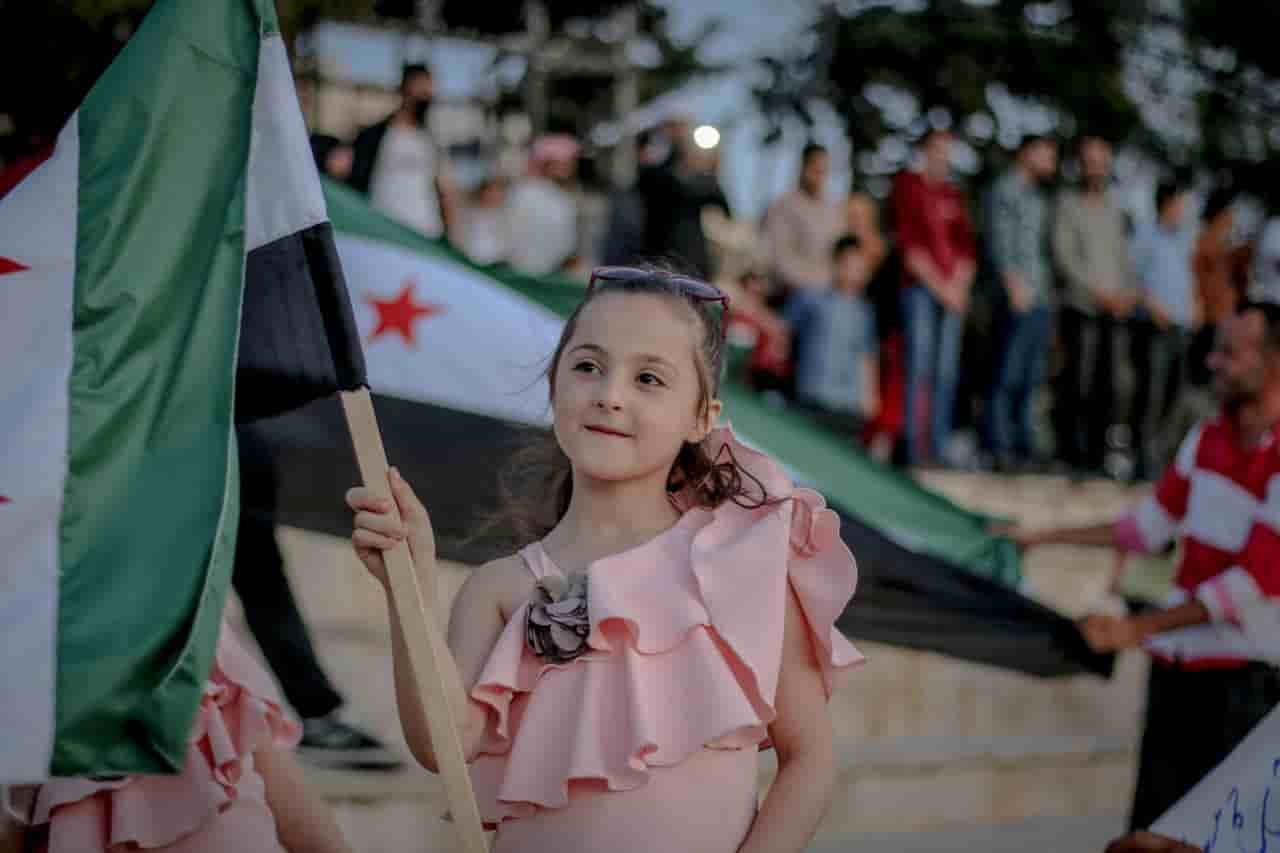 happy syrian girl with syrian flag